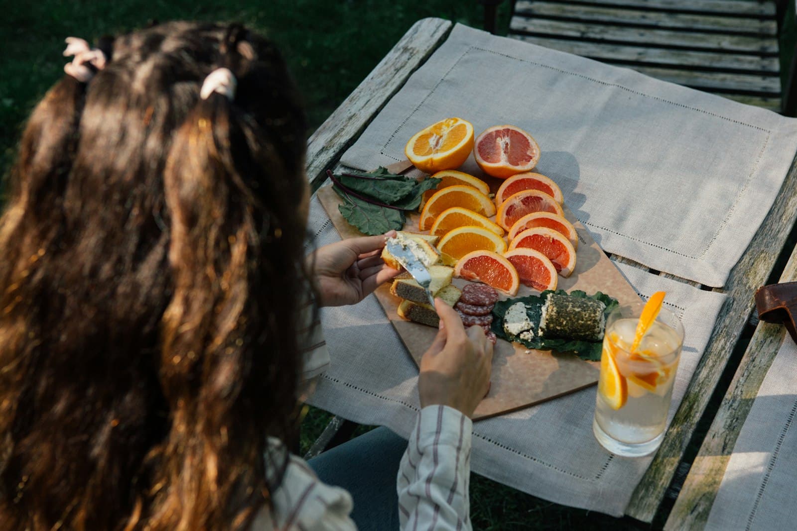 An outdoor table with a healthy breakfast of fresh fruits and vegetables